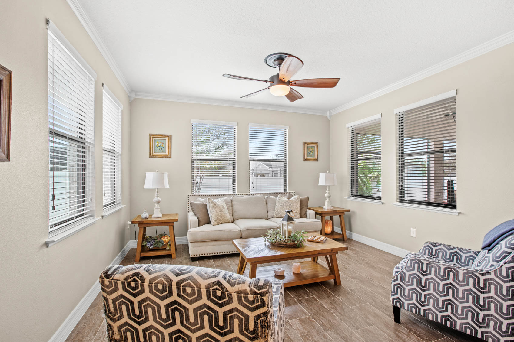 room with couch and chairs with windows